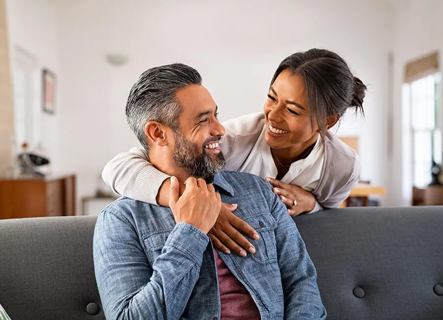 Couple hugging on a couch