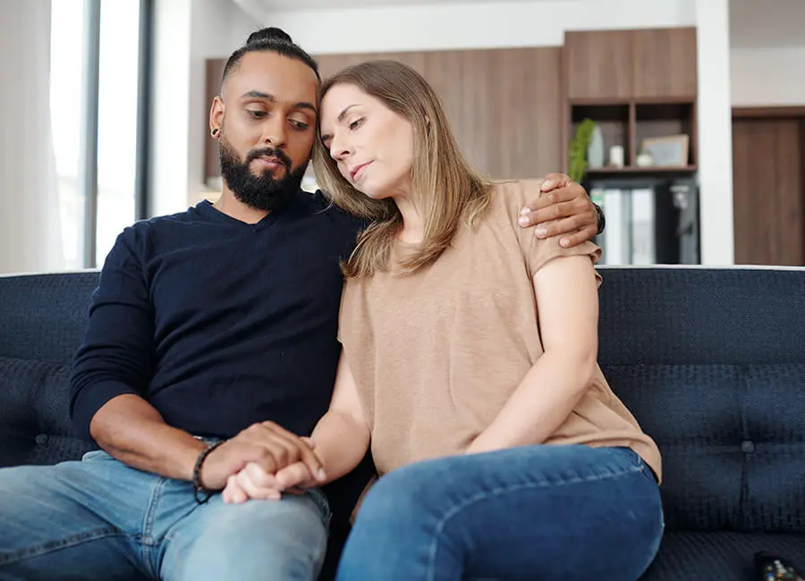 Sad couple sitting on a couch