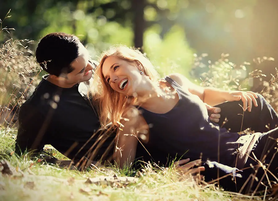 Couple laying on the grass in the sun